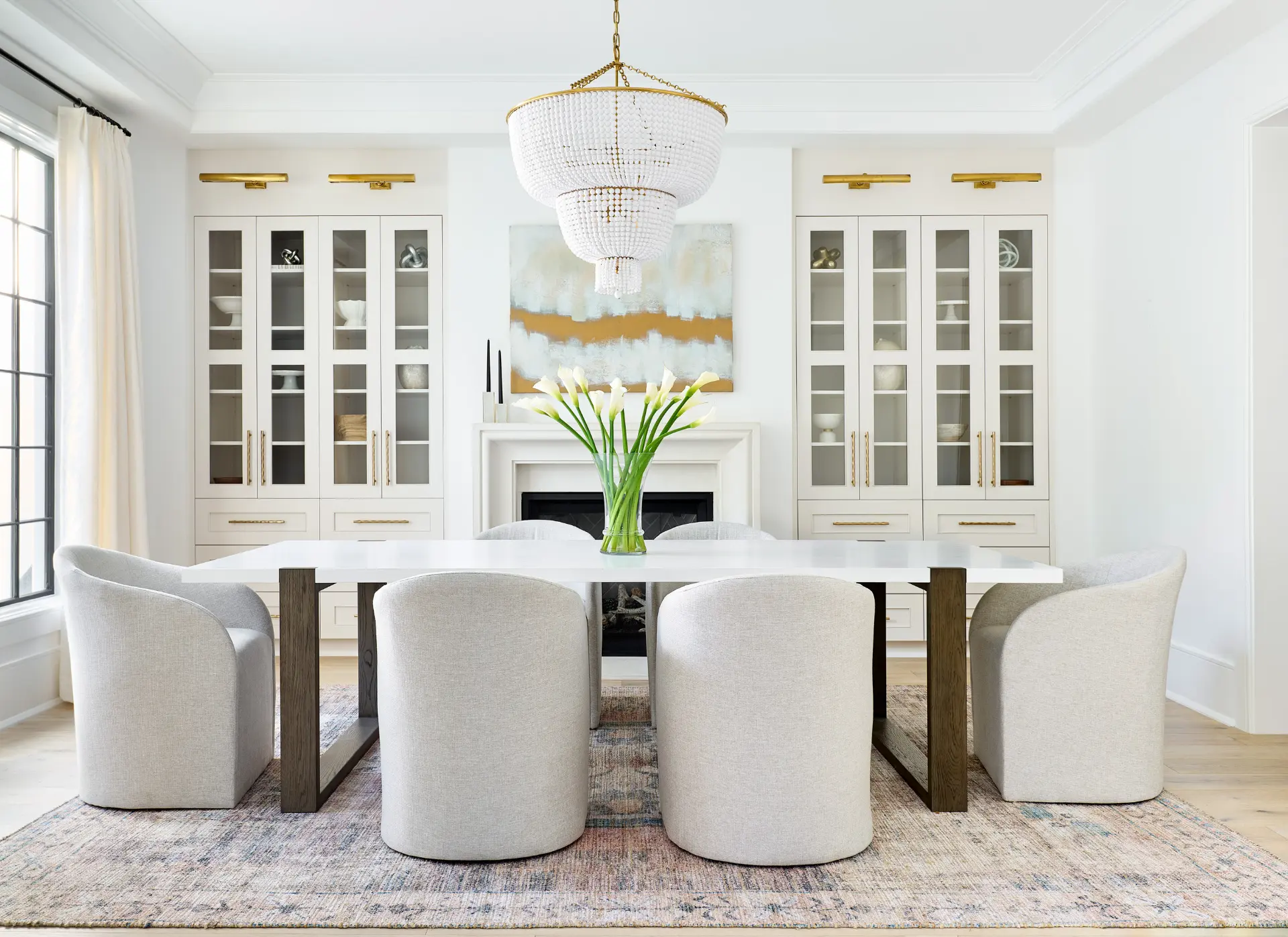Elegant dining room with beaded chandelier, glass-front cabinets and gold accents in Charlotte NC luxury home for sale