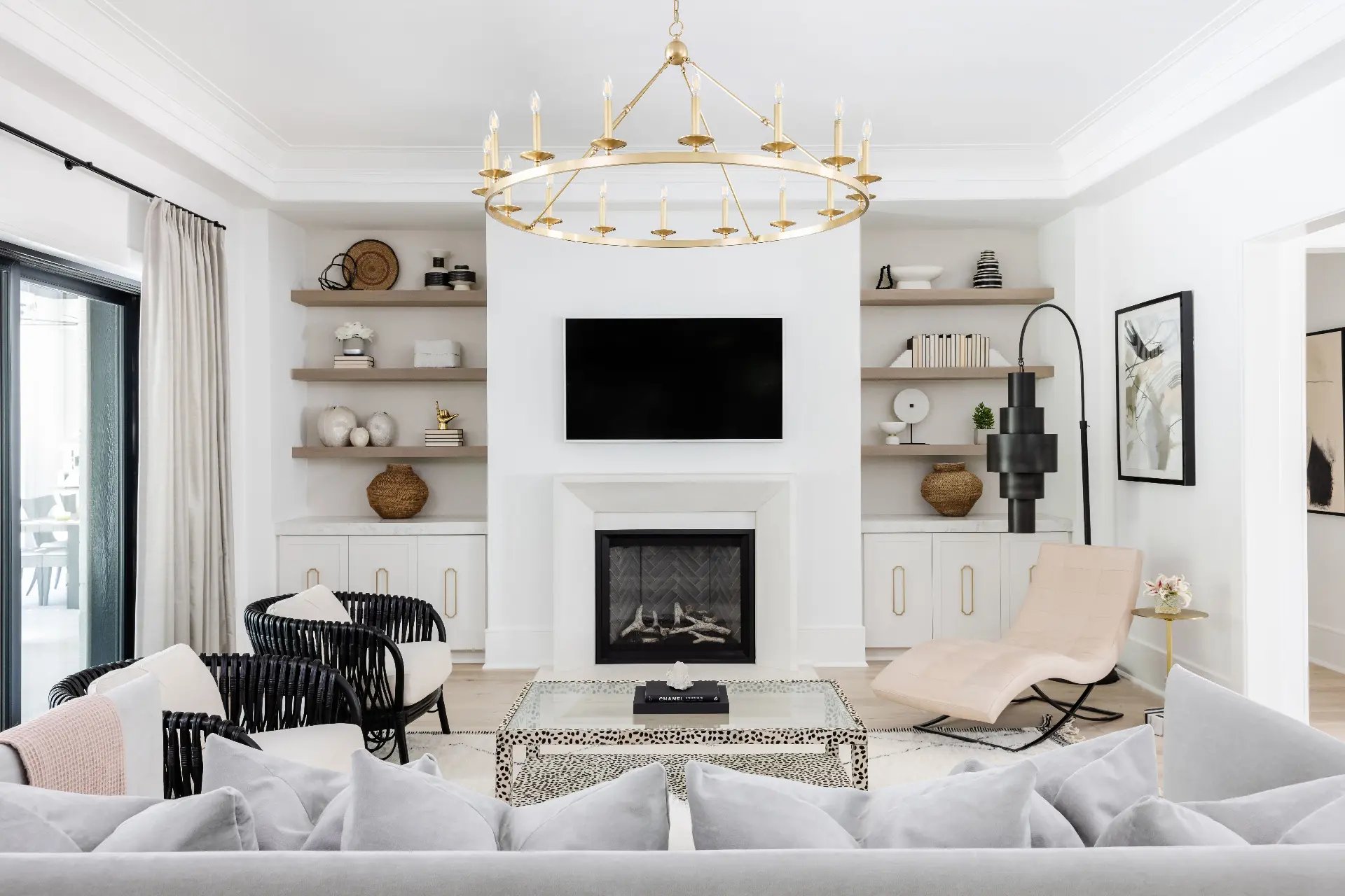 Luxury living room with gold chandelier, fireplace and designer furnishings in Charlotte NC home for sale