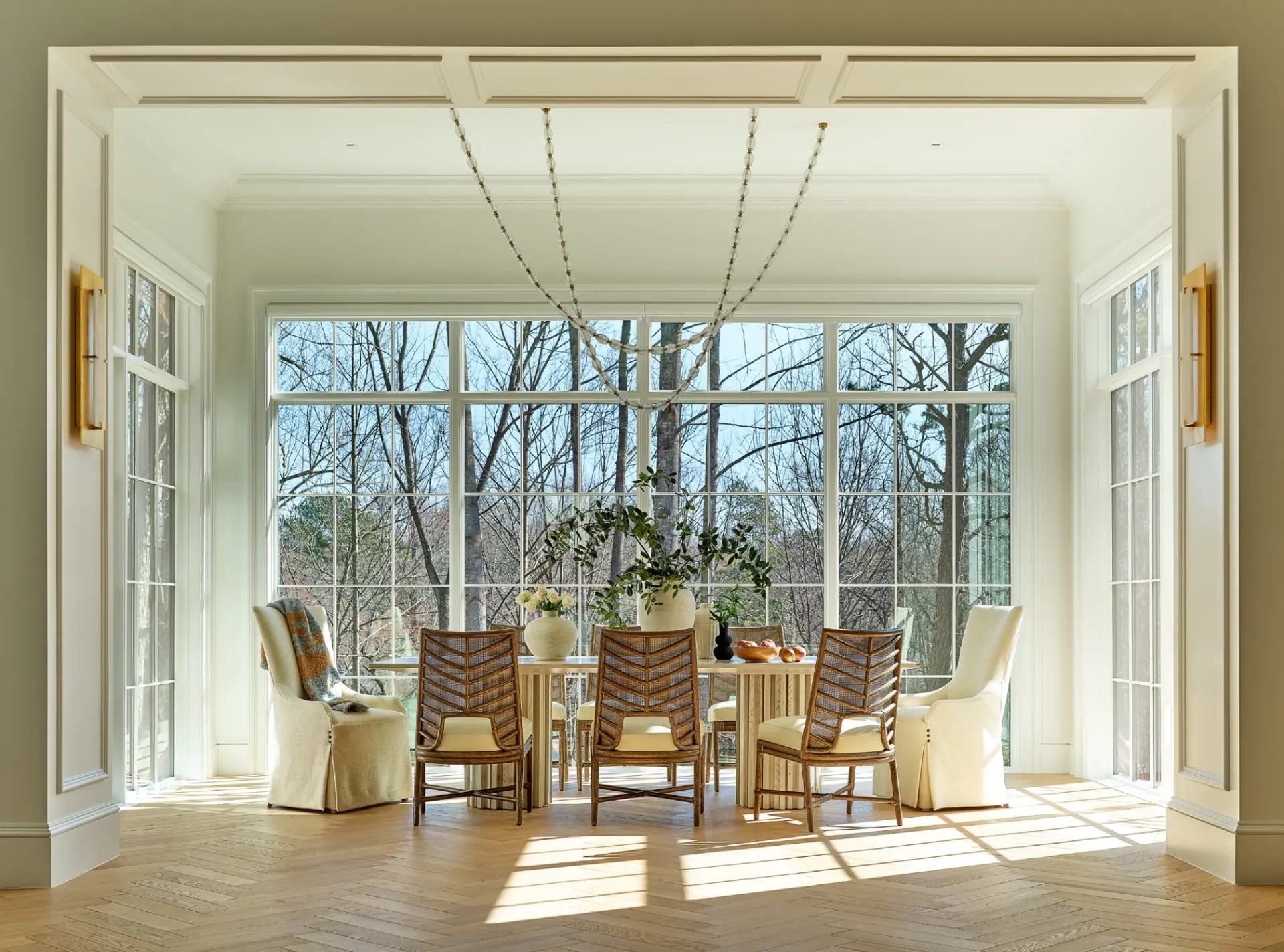 Sun-filled breakfast room with herringbone hardwood floors and floor-to-ceiling windows in Charlotte NC home for sale